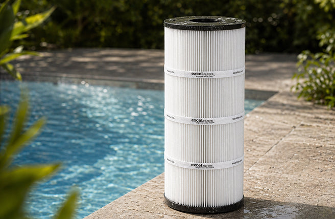 Excel replacement pool filter cartridge beside a pool
