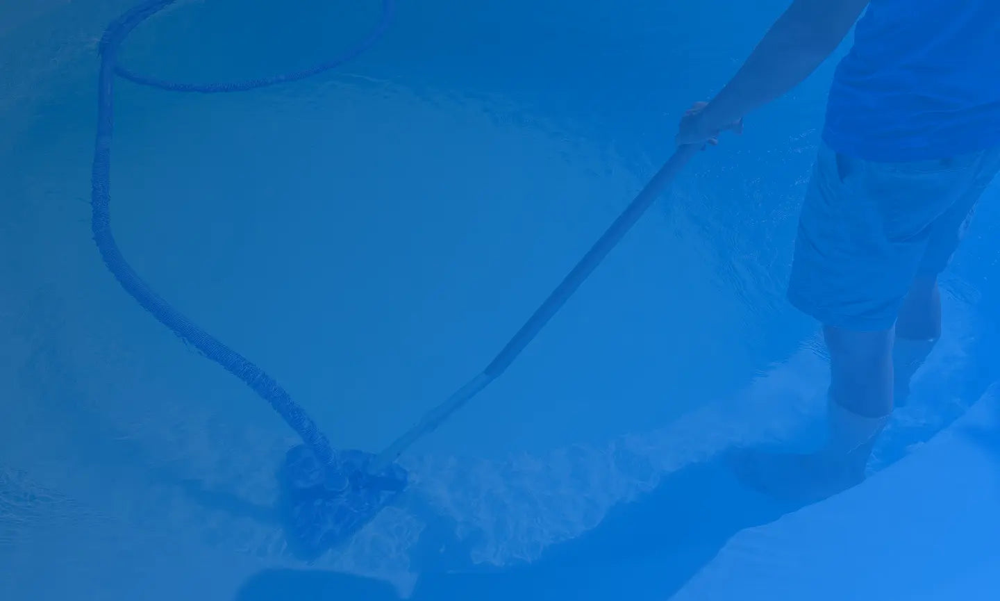Pool service professional cleaning a pool